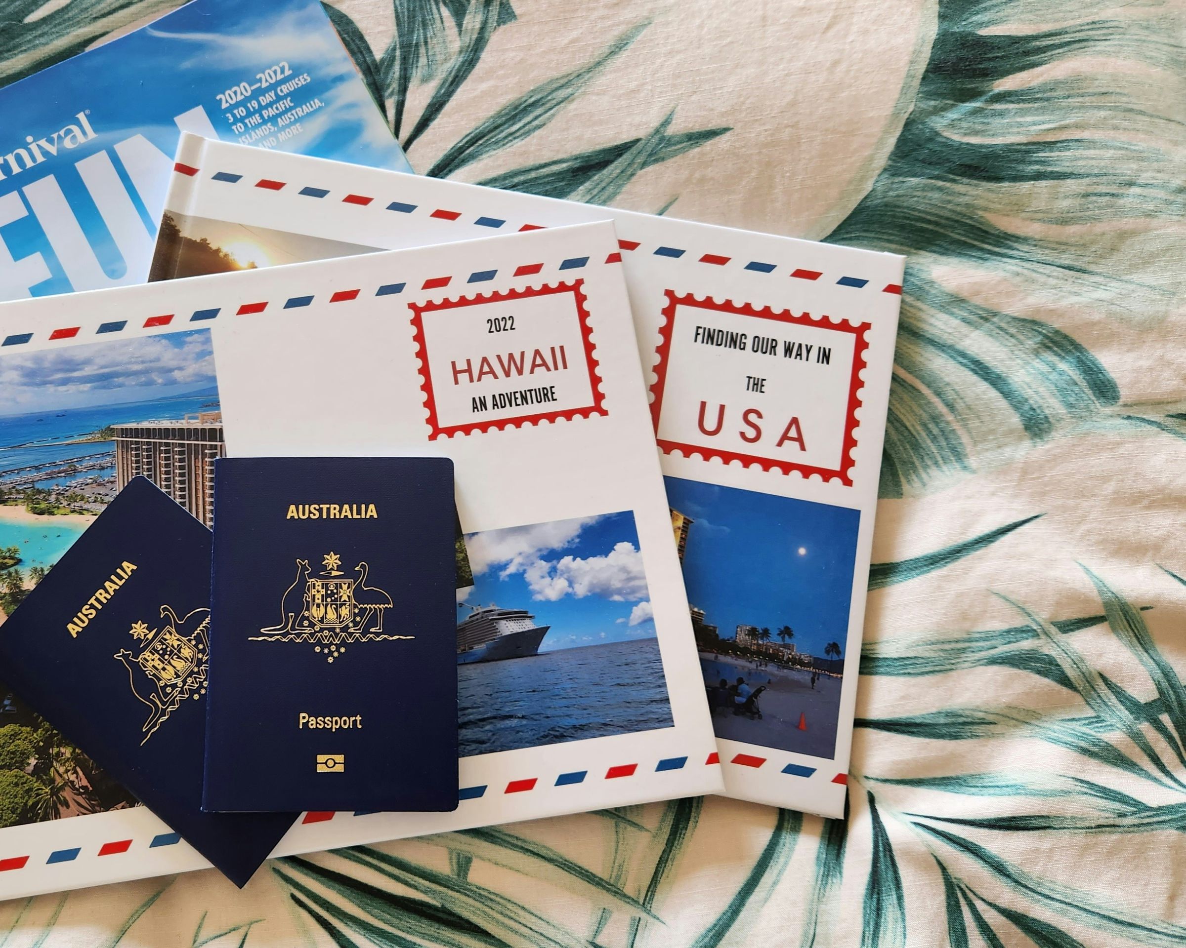 Two Australian passports on travel documents and postcards